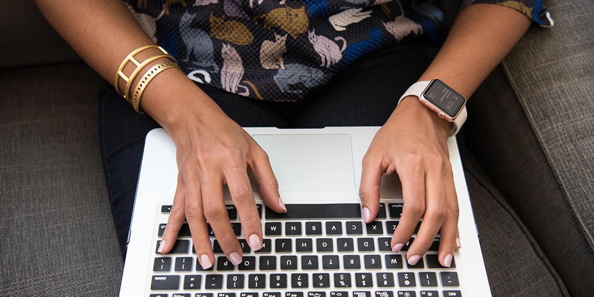 Photograph of a woman's hands on laptop